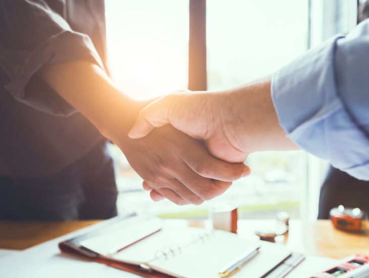 Business engineer team shaking hands to agree to joint business